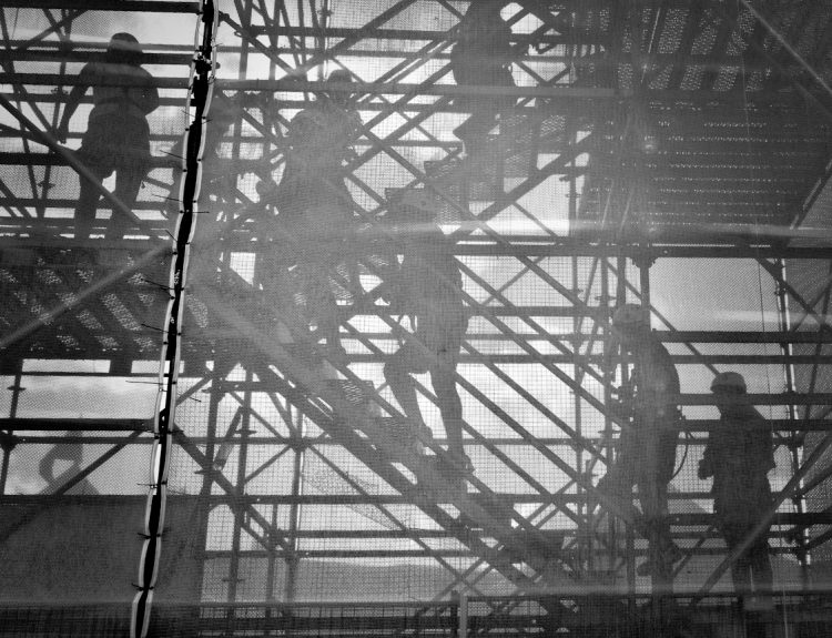 black and white photo of people going upstairs
